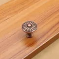 Detailed top view of red bronze drawer knob with sunflower relief on wood - Red Copper - Small
