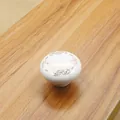 Detail of round white ceramic cabinet knob with elegant gold floral European motifs - Round Single Hole Handle (1004-38-04)