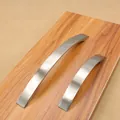 Modern brushed aluminum cabinet handles with curved ergonomic design on wooden board - 5015 Brushed-160mm