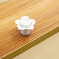 Detailed view of a white ceramic lotus flower drawer knob with multi-layered petals - White