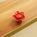 Detailed view of red ceramic lotus flower knob with glossy glazed finish for cabinets - Red