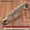 Detail of bronze door handle with dimensions showing total length 297mm and ornate texture - 297mm / Vintage Relief - 9820 / Antique Bronze