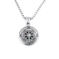 Macro shot of silver compass pendant featuring engraved dial and chunky square chain - Compass Style