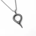 Detailed macro view of Ouroboros snake pendant with fine scale textures and link chain - Snake Loop Style