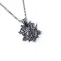 Macro detail of Nordic Viking wolf head pendant with intricate silver steel carving - Crow Style