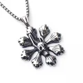 Close-up of vintage steel skull pendant with gothic floral bone texture and oxidized finish - Skull Flower with Stainless Steel Chain