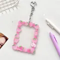 Pink strawberry acrylic photocard holder keychain with a heart-shaped metal clip - Strawberry