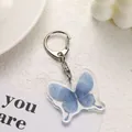Llavero de mariposa azul Y2K en acrílico con patrón estrellado y fondo moderno - Mariposa Cielo Estrellado Azul (4)