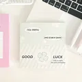 Foldable minimalist green clover gift card packaging on a clean office desk - Large Card Head - Four-Leaf Clover