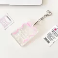 Clear acrylic photocard holder with pink ribbon design and heart metal keychain - Pink