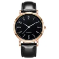 Gros plan d'une montre à quartz rose doré avec chiffres artistiques sur cadran noir mat - Cadran Noir Bracelet Noir