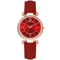 Detailed macro view of the red sunburst dial and rose gold case on women's quartz watch - Red
