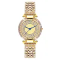 Close-up of gold-tone luxury watch showing crystal-set bezel and blue hands on radial dial - Gold