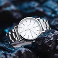 Close-up of a silver steel men's quartz watch with white dial on black textured rock - GD253 Three Sub-dials White Dial