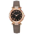 Detalle de bisel de estrella de mar oro rosa y esfera floral negra en reloj de mujer - Gris