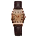 Macro shot of rose gold tonneau watch case with Roman numeral dial and brown leather strap - Coffee
