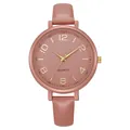 Detailed view of women's quartz watch featuring pink dial with gold numeral markers - Rouge Red