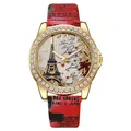 Macro view of gold quartz watch with Eiffel Tower dial and red leather strap detail - Red