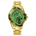 Close-up of green shield dial watch with magnified date display and golden steel band - Gold Green