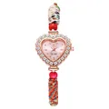 Detail of heart-shaped quartz watch with rhinestone bezel and colorful woven strap - Pink
