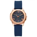 Detail of rose gold case with navy blue silicone strap and radial pattern dial - Blue