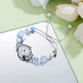Detail of creative pearl bracelet watch with blue beads and mirror base reflection - 6536 White Face Numerals