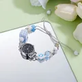 Detail of beaded bracelet quartz watch with blue blocks and charms on a mirror - 6536 Black Face Numerals