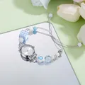 Elegant quartz wristwatch with blue checkered beads and pearls on light green background - Sunray White