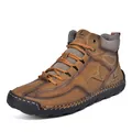 Detailed view of hand-stitched leather texture and durable rubber toe on brown boots - 38 / Tan