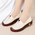 Beige women's flat loafers with contrast stitching and non-slip rubber sole on model - EU 38 / White