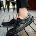 Men's black leather slip-on loafers with hand-stitched detailing on outdoor deck - EU 38 / Black