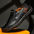 Hand-stitched men's black leather loafers with rubber sole on a wooden stool - EU 38 / Black
