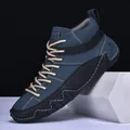 Close-up of blue nubuck and black leather high-top shoes with white stitching detail - Dark Blue