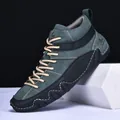 Detail of dark green suede high-top boot with white stitching and wavy sole design - EU 38 / Dark Green