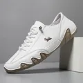 White leather casual shoes for men with wave-patterned rubber soles and goat logo - White