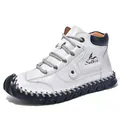 Detail of white leather boots featuring blue collar trim and handmade stitching - EU 38 / White