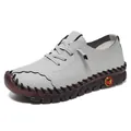 Light grey handmade leather loafers with pebble grain texture and hand-stitched soles - Gray