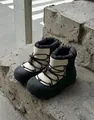 Detailed view of children's thick snow boots with non-slip rubber soles and warm lining - Off White