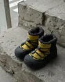Detail of waterproof winter snow boots featuring a warm yellow nylon upper and rubber sole - Yellow