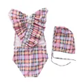 Flat lay of girl's striped ruffle swimsuit set with matching swim cap in macaron plaid - Colorful Grid Cross Strap