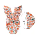 Detailed view of baby girl swimwear with orange fruit patterns and ruffled shoulders - Fresh Orange Cross Strap