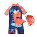 Flat lay of blue and orange kids dino swimsuit set with a matching dinosaur swim cap - S / Navy Speed Skating Dinosaur Pattern