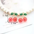 Red cherry jewelry charm with green leaves and gold stem measuring 2.7cm by 2.3cm - Transparent Big Red Cherry