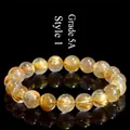 Grade 5A natural golden rutilated quartz crystal beaded bracelet on a black reflective surface - 7-7.8mm (Approx. 25 Beads) / 5A Grade Gold Rutilated Style 1