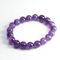 Macro shot of natural amethyst beads showing clear textures and polished round surface - 10mm