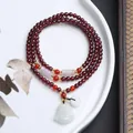 Detailed view of multi-layer garnet bead bracelet with jade Buddha charm and gold accents - A4 Maitreya Buddha