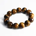 Natural tiger eye stone bead bracelet with silk sheen texture and cat eye effect on white background - 16mm Bead