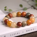 Natural colorful silk jade beaded bracelet for men and women on a minimalist white book - Large Round Bead Style