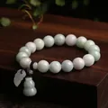 Natural jade bead bracelet with gourd pendant on a dark wooden display stand - Gourd