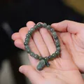 Natural green jade bead bracelet featuring a detailed Pixiu charm and green tassel - Small Oily Green Beads With Pixiu Style